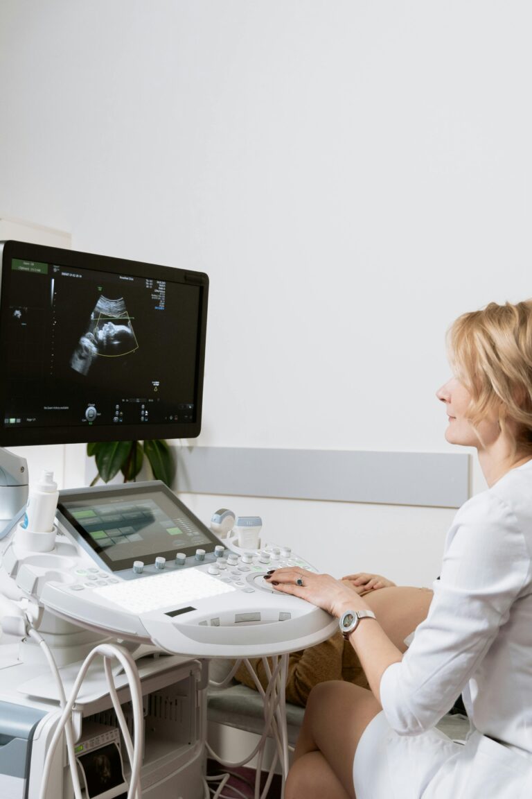 Female doctor using an ultrasound machine in a medical clinic